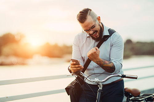 image of excited person with phone in hand